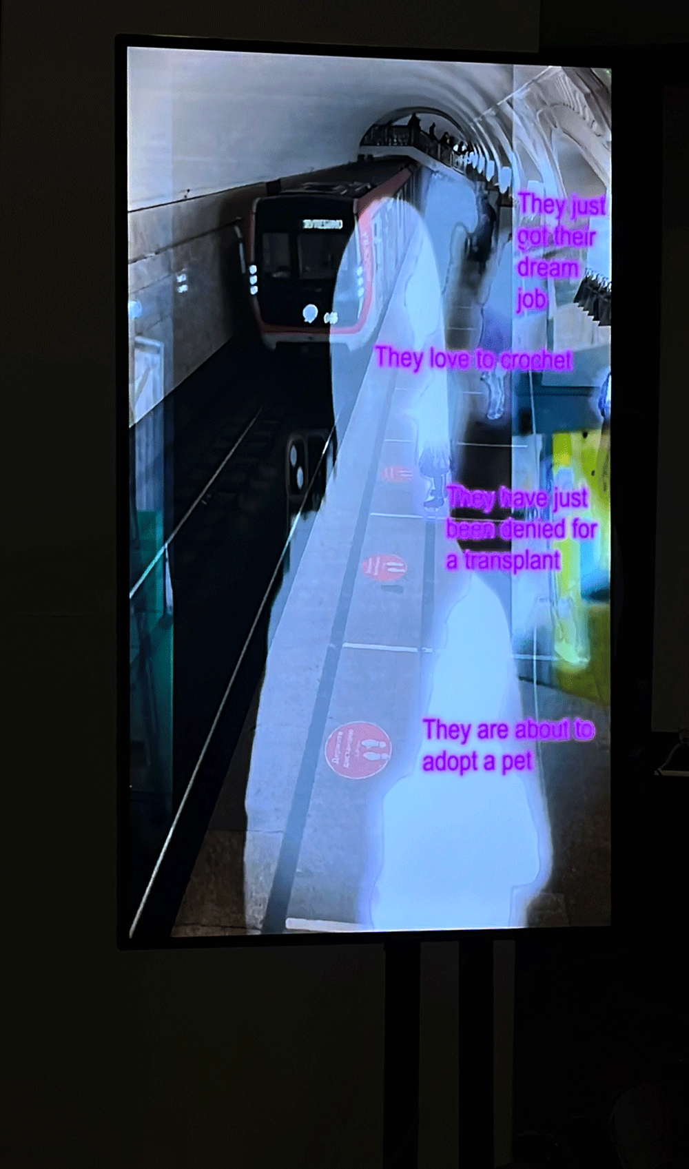 reflection superimposed on video of people waiting for the subway to arrive